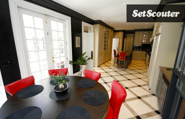 This open concept kitchen includes a great breakfast nook that features the dash of red theme that is found in the kitchen. Separating the two areas are double doors which lead outside and provide additional light and space.