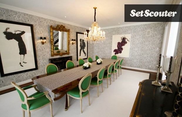 This dining room is incredible. I don't know if it is the patterned wallpaper, the motion that the art gives off or the green upholstered chairs, but this room has got it going on.