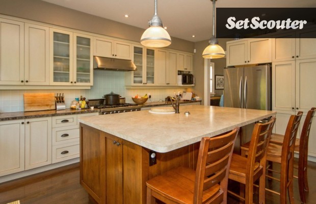 Dorin's kitchen is warm and cozy, the neutral tones are classic while the large island and stainless steel appliances are high-end and contemporary. This space is the perfect set for any production seeking a family home kitchen.