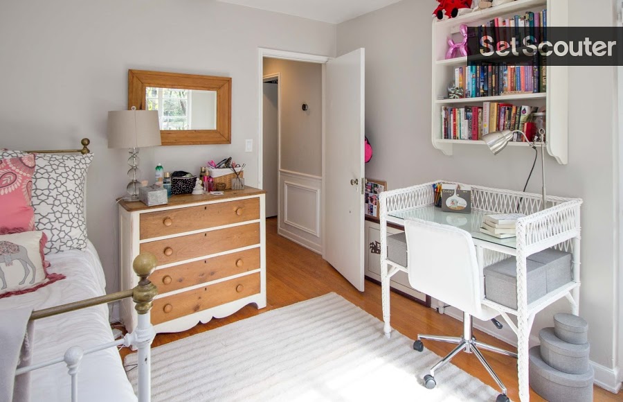 This adorable second bedroom is extremely versatile with its light grey walls and white decor. The girly, beach inspired furniture makes this room stylish, yet modern - the perfect look for production. The quaint study space including a mounted bookshelf is an added bonus to Alison's space!