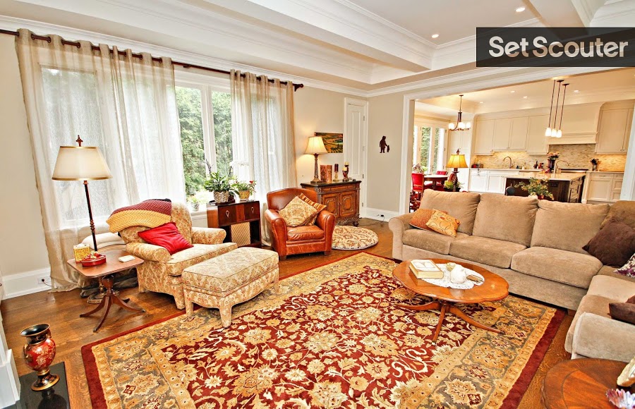 Linda’s large living room exudes classic comfort with unique flair, the earthy tones and warm colours compliment the patterns and varying textures in the space. A traditional, leather reading-chair serves as a statement piece while hard wood floors and neutral walls add elegance in this fun living room.