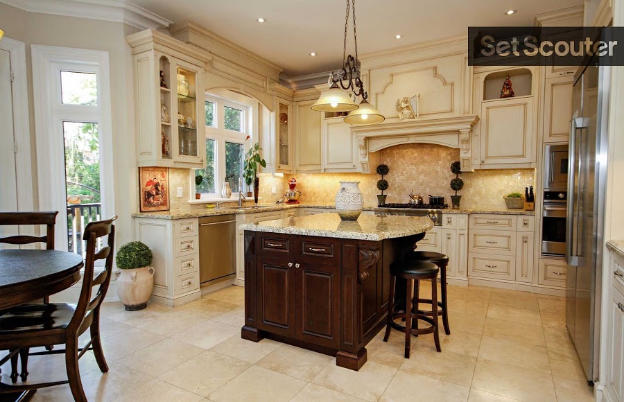 Rich wood and natural light make this large, open concept kitchen warm and cozy. Granite countertops and stainless steel appliances are simple and stylish while the lavish detailing of the cupboards stands out.