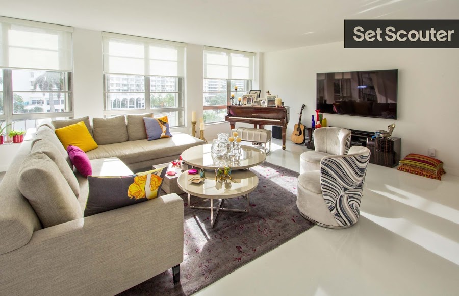 A grand piano makes a smart addition to this living area. A cream sectional with bright accent pillows complements the relaxed vibe of the space. Keeping with a white foundation forgives the mixing of patterns and colors without the room looking too overwhelmed or mismatched.