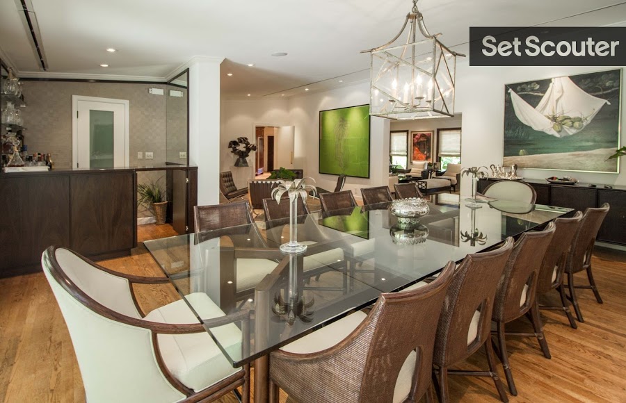 The dining area is modern, with clean lines and rustic touches throughout. The room looks effortless, perfectly pairing hardwood floors, creme colours, and unique pieces such as the candle light fixture. Features like the bar and contemporary art pieces create to an upscale look.