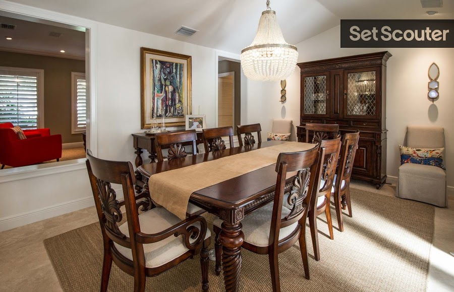 Mariana’s dining room is classic and refined in its simplicity. A rich wood table draws the eye with intricate detailing and matching chairs. The large chandelier is functional while making for a great statement piece.