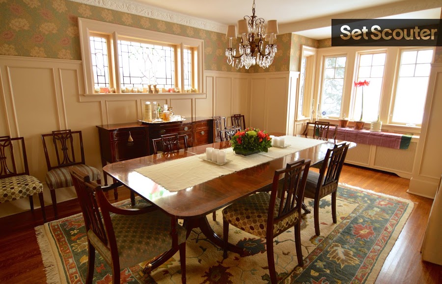 Jackie’s dining room is classic, with a personal touch and eclectic feel. From the upholstered dining chairs and beveled glass window, to the vintage wainscotting and wallpaper — this room provides an interesting backdrop for several different scenes. The bright reading nook is a bonus!