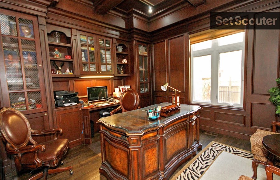 An noble, wood décor office keeps with the illustrious theme throughout Amel's home, while unique patterns and designs add a contrast in character. An antique, solid wood desk along with it's matching leather, office chairs is a bold and handsome centerpiece.
