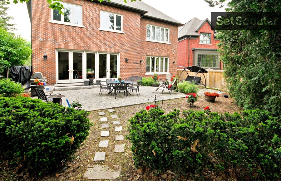 Behind this red brick home is a comfy and well-kept back yard with furnished patio, stone path and cozy swing set for two. A short wood fence divides the yards between homes, setting the scene for a suburban exchange between friendly neighbours. Borrow a cup of sugar?