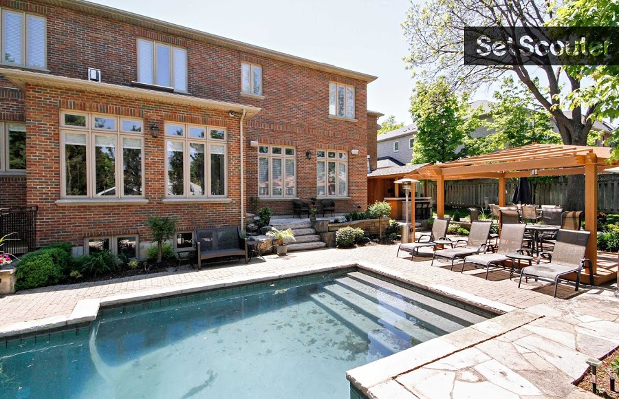 Behind the home is the perfect area for lounging in the sun. The large yard surrounds an underground pool with tons of room for seating and a small garden. Details like the marble deck and potted plants display Esti's love and care and would be a good match for a character or family who is fun and stylish.