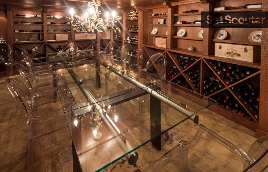 What sets this home apart is a spectacular wine cellar that also doubles as an entertaining space. Concrete floors are offset by upscale lighting and simple furniture. Minimal decor means this space can be easily converted into any backdrop.