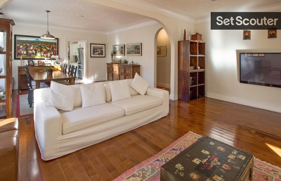 An arched entry opens Juan's formal dining room into his chic living room area and it's touches of rustic charm. Sleek hardwood floors complement the fresh, cream furniture and make a gorgeous staple throughout the home. This open space is welcoming and cozy with great character.