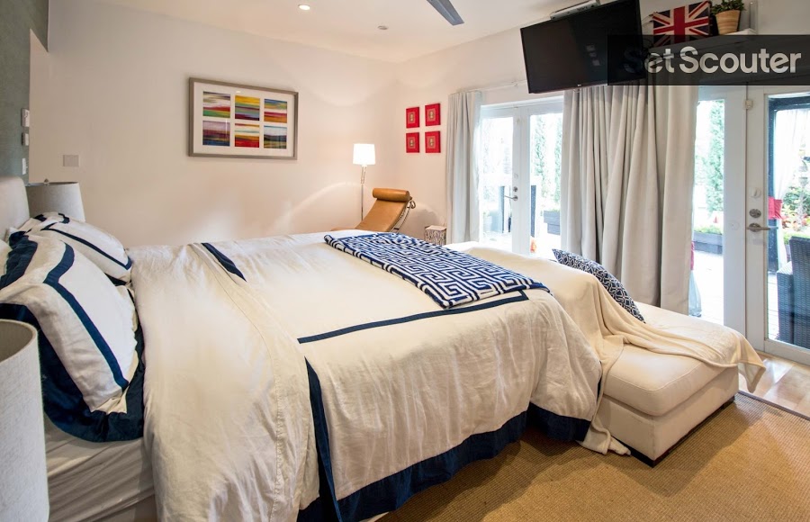 In the second bedroom, white and navy blue complement each other to give the room a Greco inspired, Mediterranean feel. Large windows and clean white walls open up this room making it the perfect at-home retreat.