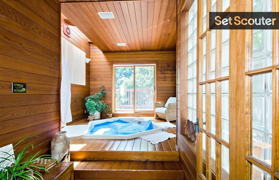 Every cozy spot in Rhonda's home has it's own personality with smart and consistent, wood accents. This gorgeous sunroom spa including a luxury hot tub has wall-to-wall wood paneling, large windows and a sliding glass door heading out onto Rhonda's great, wrap-around patio.