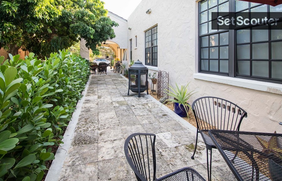 A patio along the side of Juan's home houses some great, private seating areas to enjoy the outdoors. From two delightful bistro sets, to a patio fireplace and lively decor along the walkway, this long and unique outdoor space is the ultimate outdoor hideout.