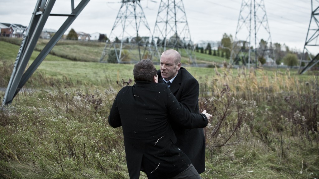 Mike (Hugh Dillon) and Ivan (Michael Nardone) fight under hydro towers on Durham County.