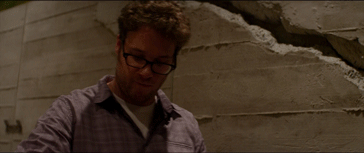 Seth Rogan duct tapes a wall